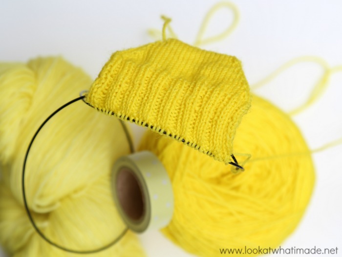 A crocheter knitting socks