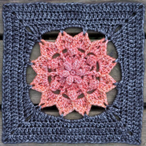 floral crochet square with colourful centre and dark background